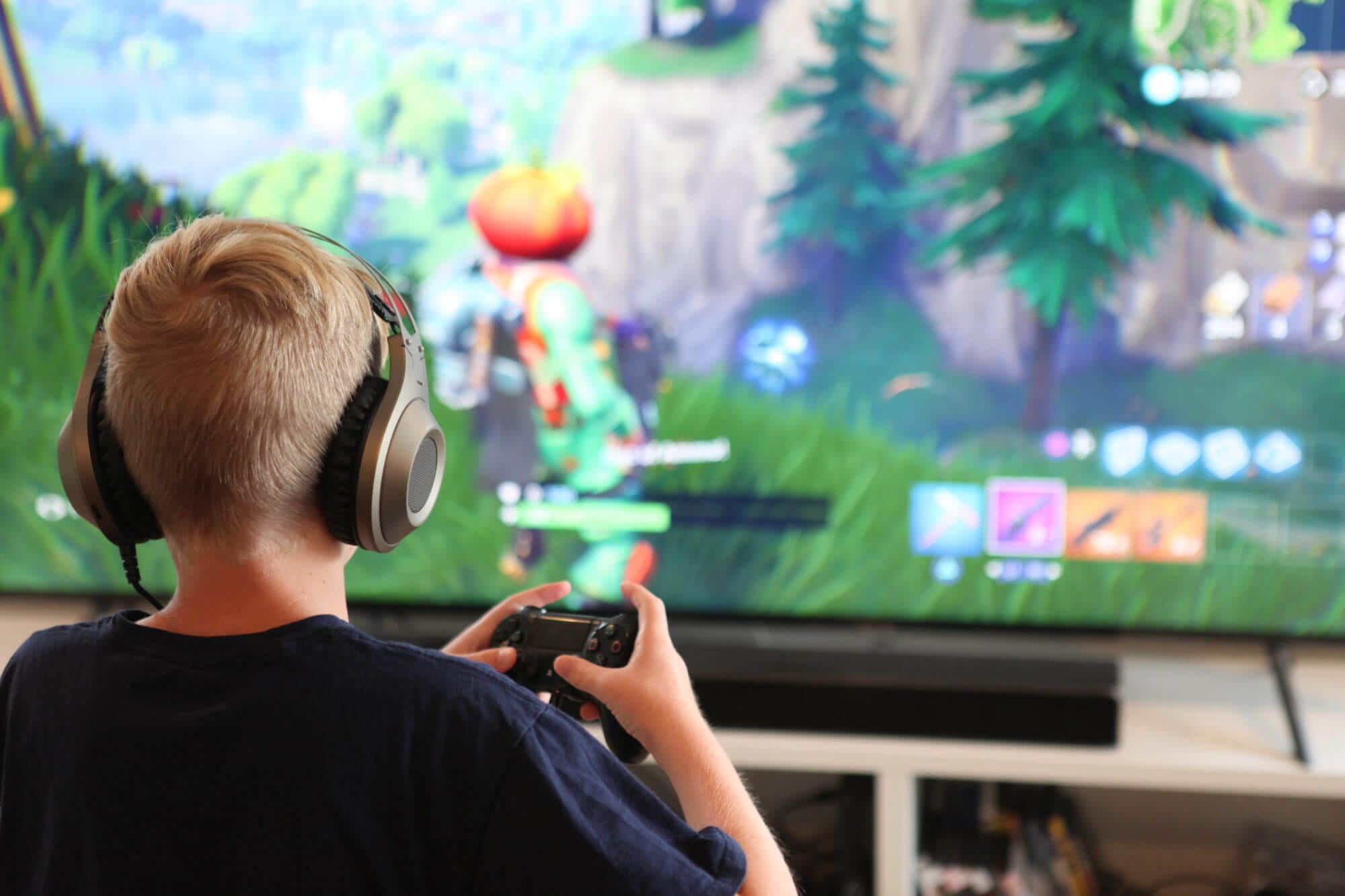 kid playing fortnite on a video console