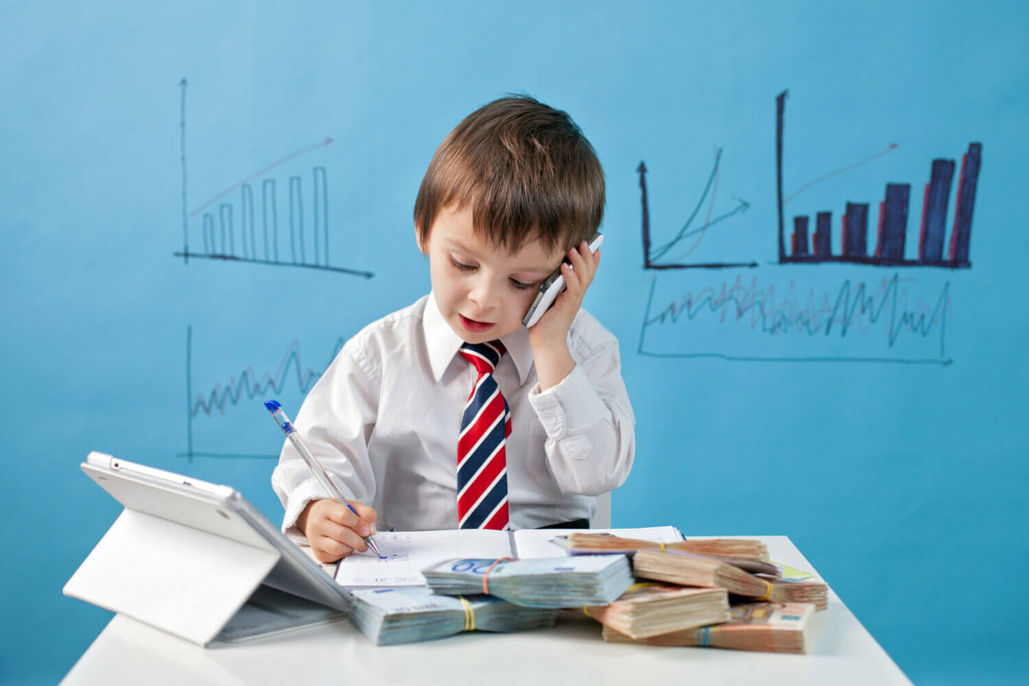 child talking on the phone with money laying on the desk