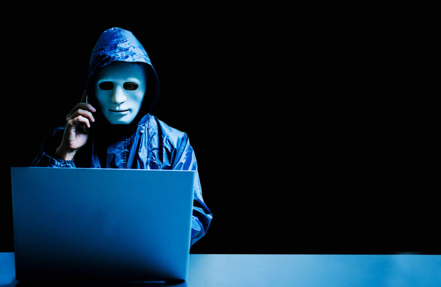 a hacker in a phone call and on a computer
